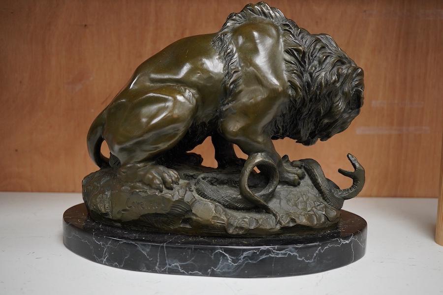 A patinated bronze group of a lion and snake, J.B Paris foundry stamp, signed Coreira, on a black marble base, 23cm high